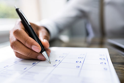 Someone filling in a calendar